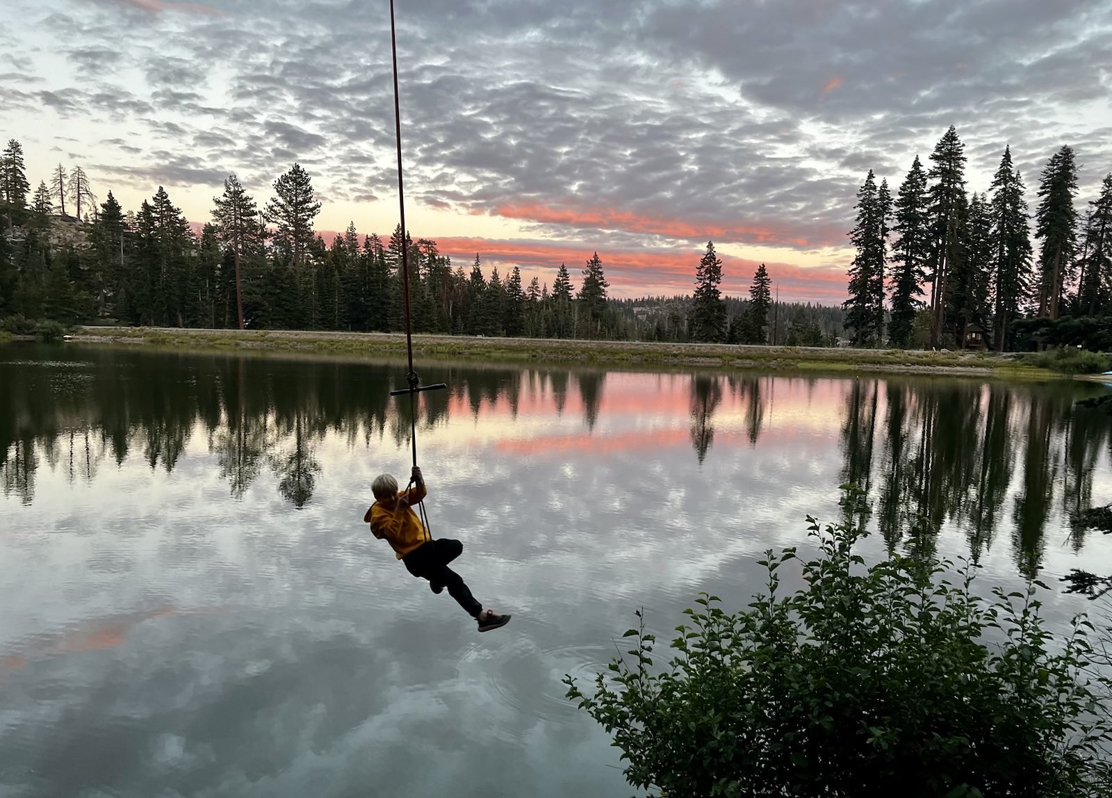 Rope swing over Bear Lake at sunset